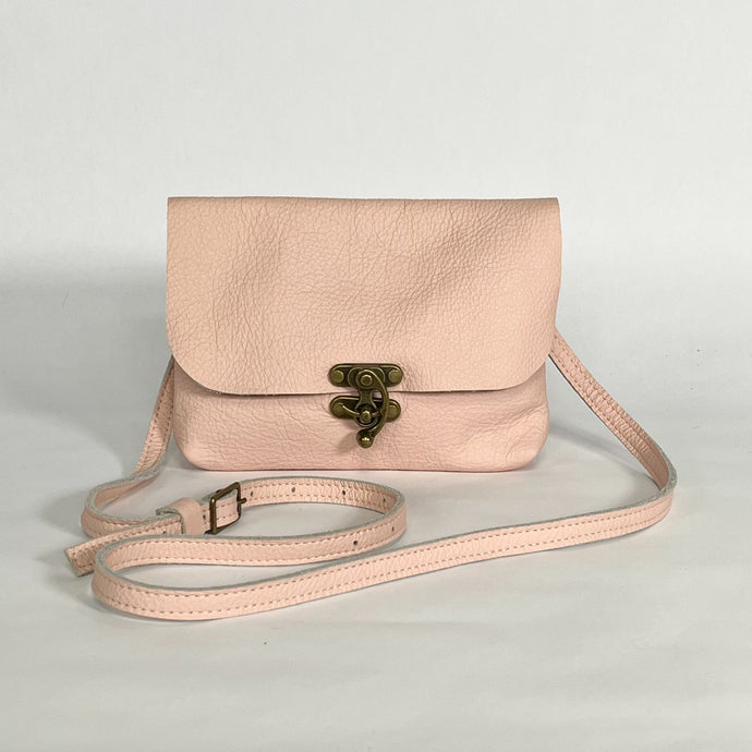 small pink leather crossbody bag with antique brass swing clasp